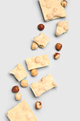 Sweet white chocolate with nuts on  light background