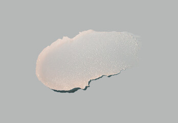 Cosmetic white pink lip balm or face cleansing balm butter swatch isolated on gray