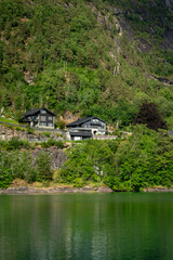 Obraz premium small house on the river in mountains