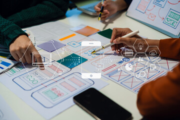 Creative digital development agency. developer team brainstorming on their project with laptop, smartphone and digital tablet.