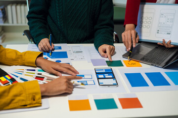Creative digital development agency. developer team brainstorming on their project with laptop,...
