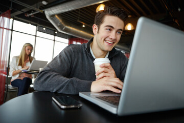 Cafe, reading and man with laptop, smile and freelancer with coffee in morning, writer and creative. Customer, entrepreneur and editor for ebook, remote work and happy in shop for tea and internet