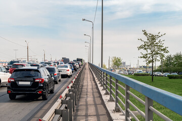 Background, blur, out of focus, bokeh. Traffic jams during rush hours after work. Red brake lights of stopped cars on the background of the city neighborhood.
