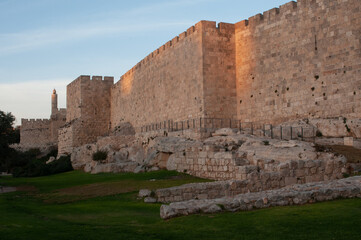 Section of the walls of the Old City of Jerusalem and the Tower of David citadel at sunset in...