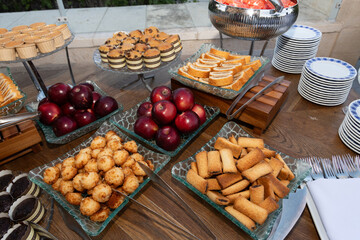 Buffet table with an assortment of fresh fruits and kosher for Passover baked goods.