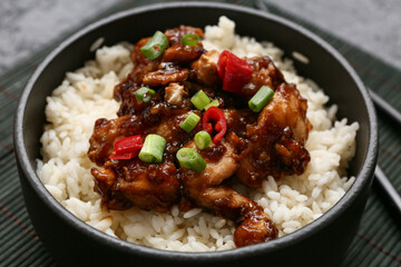 Tasty sweet and sour chicken with rice in bowl, closeup