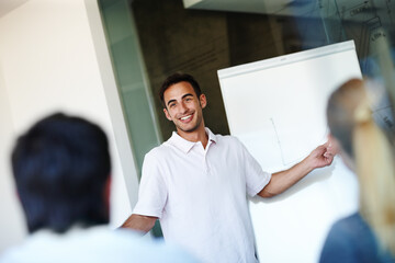 Happy businessman, presentation and meeting with whiteboard for project or team discussion at office. Young man or speaker talking to employees for company ideas, growth or development at workplace