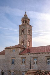 Vertical shot of the Dominican Monastery bell-tower against blue dusk sky in Dubrovnik, Croatia