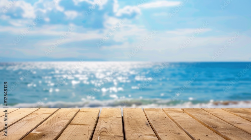 Wall mural wooden deck overlooking a blue ocean with a blurred background