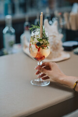  A vibrant and colorful fresh fruit cocktail served in a glass, showcasing a mix of tropical fruits, perfect for a refreshing summer treat by the beach.