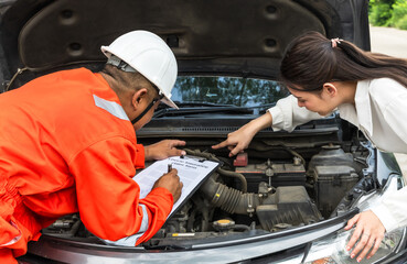 Car mechanic man checking list on vehicle damages with owner pointing on problem