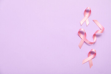 Pink silk ribbons on lilac background. Breast cancer concept