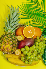 Set of fresh tropical fruits. Ripe mangoes, pineapple, oranges, grapes and bananas