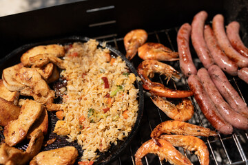 The ultimate summer feast chicken rice shrimp and sausages on the grill