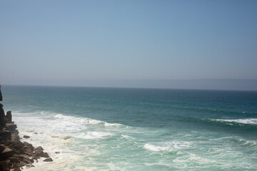The ocean stretches out endlessly waves gently crashing on the shore