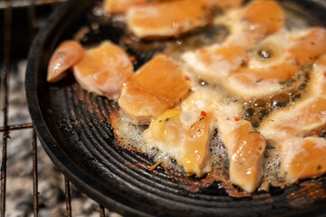 Chicken sizzling in a hot pan ready to be devoured