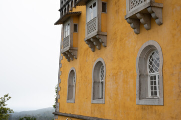 A yellow building with intricately carved windows The building looks like it could be a castle