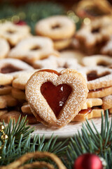 Heart shaped Linzer Christmas cookie filled with red strawberry marmalade and dusted with sugar