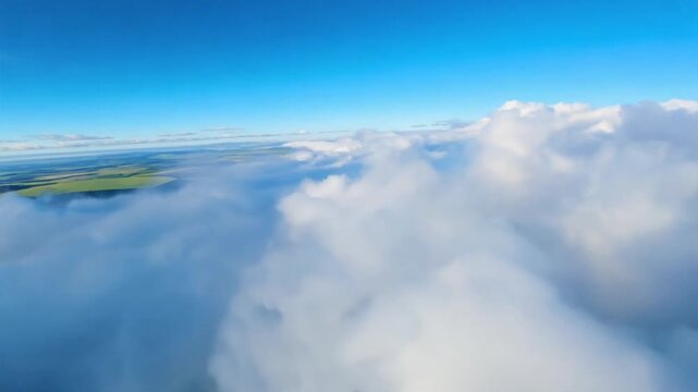 Flying above clouds with green fields visible below