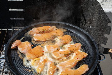 Chicken breast sizzling on a hot grill ready for a delicious summer meal