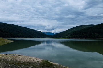 Colorful landscape with forest, lake, reflection in water