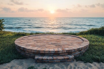 Naklejka premium Empty brick podiums displayed on sand beach with some green grass. Front view, the sea background is gradually evening with a beautiful pink sunset. Pedestal for display product, ai