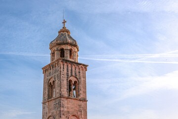 Ancient church bell tower against a blue sky on a sunny day in Dubrovnik, Croatia