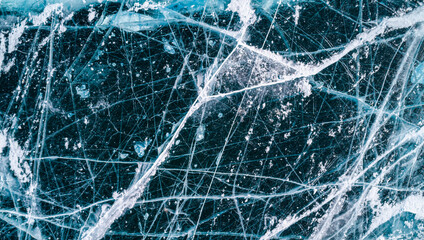 Aerial top down view on the blue cracked ice of the lake Baikal. Winter landscape, frozen lake. Ice kingdom.