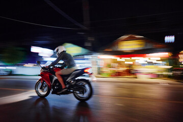 Night at the city. Man riding motocycle.