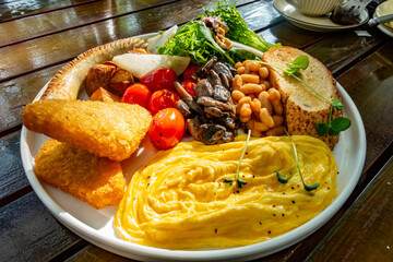A cooked breakfast on a wooden table at a restaurant.