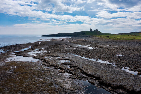 Dunstanburgh Castle and rocky shore