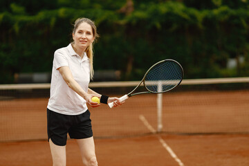 Female tennis player playing tennis on an open tennis court