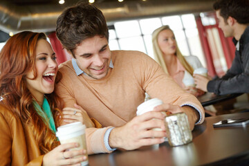 Laughing, happy or couple at coffee shop to relax on romantic, anniversary or morning date. Smile, break or funny people bonding at cafeteria, breakfast or restaurant for drinking cappuccino together
