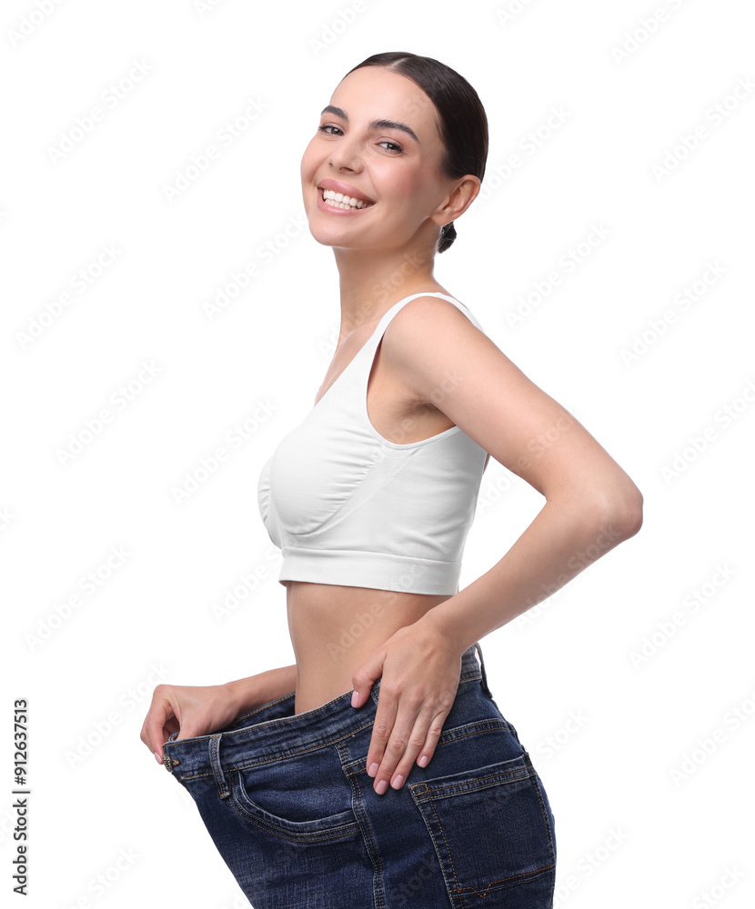 Poster Diet and weight loss concept. Happy young woman in big jeans showing her slim body on white background