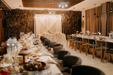 A beautifully designed wedding reception hall where the bride, groom, and guests will enjoy their meal. The elegant decor and stylish setup create a perfect ambiance for the celebration.