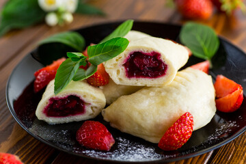 cooked sweet homemade steamed dumplings with strawberries