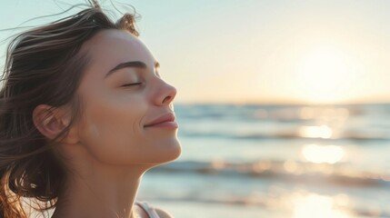 Woman breaths fresh air on the beach.