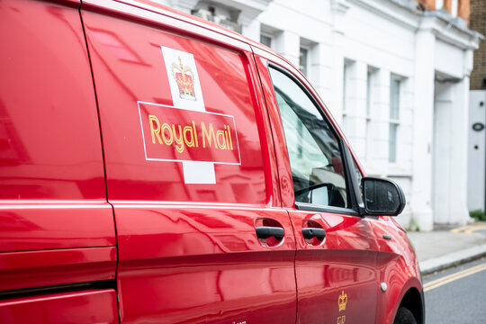 LONDON- Red Royal Mail van out on delivery in Chelsea, south west London