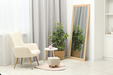 Large mirror near white wall in room. Interior design
