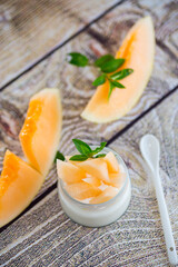 sweet homemade yogurt in a jar with pieces of ripe melon