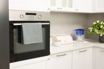 Electric oven with towel in kitchen. Cooking appliance