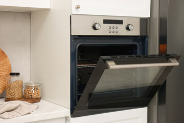 Fototapeta premium Open electric oven in kitchen. Cooking appliance