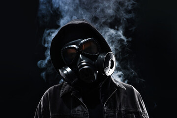 Man in gas mask on black background, low angle view