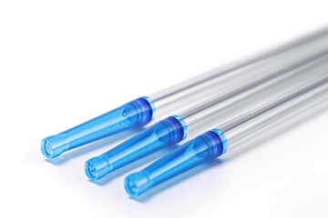 Three transparent plastic tubes with blue filters lying on a white background are depicting an abstract medical concept