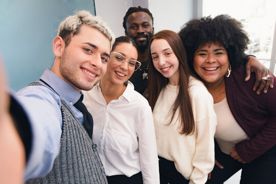 Selfie portrait photo of a team working in the office, mobile camera perspective