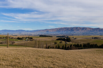 Fototapeta premium Meadow field view with the mountain in the background.