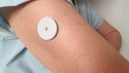Non-contact glucometer on the arm for quickly measuring blood glucose levels. Non-contact shoulder glucometer for diabetics. Device for diabetics.  Increase or decrease in blood glucose.