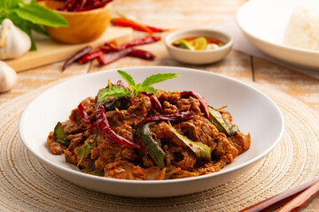 Stir fried sliced Beef with dry chilli and Holy Basil in white plate.Thai famous food (pad kra pao prik hang).