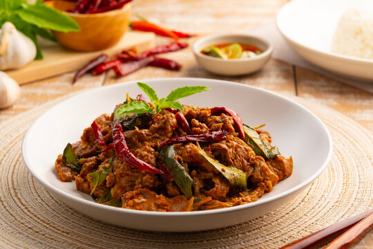 Stir fried sliced Beef with dry chilli and Holy Basil in white plate.Thai famous food (pad kra pao prik hang).