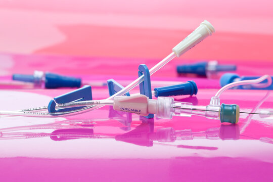 Vascular access with pressure injectable multilumen peripherally inserted central catheter kit   on pink background